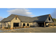 Exterior of Reliant Homes office with stone, brick, and exposed timber framing