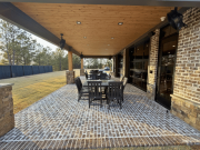 Rear exterior with covered patio and brick paving at office building