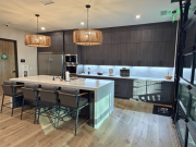 Office break room with large kitchen island, seating, and pendant lighting